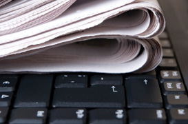 Photo of newspaper and laptop