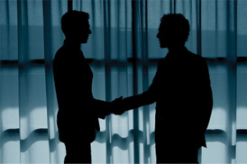 photo of two people shaking hands